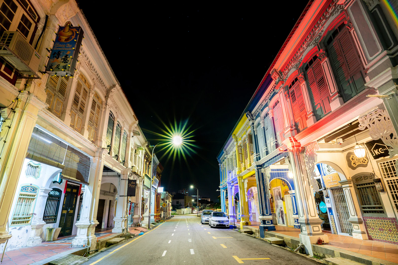 Street lined with colourful shophouses at dusk in Georgetown