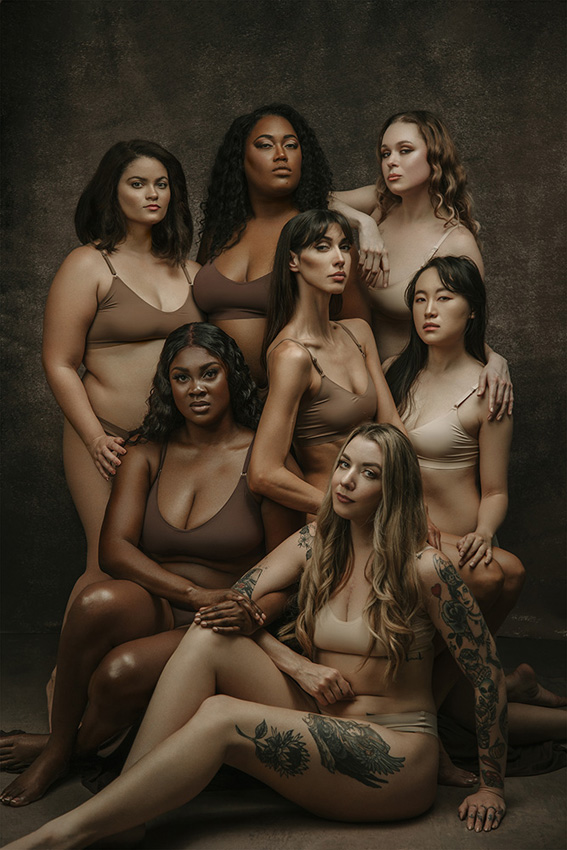 Group of women in skin-coloured lingerie staring at the camera